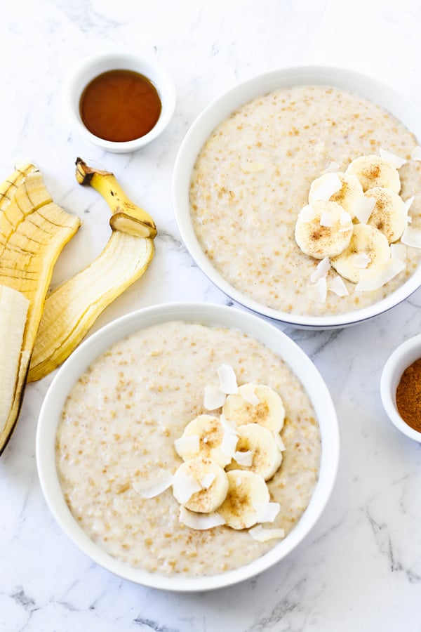 two bowls of steel cut oats topped with banana slices
