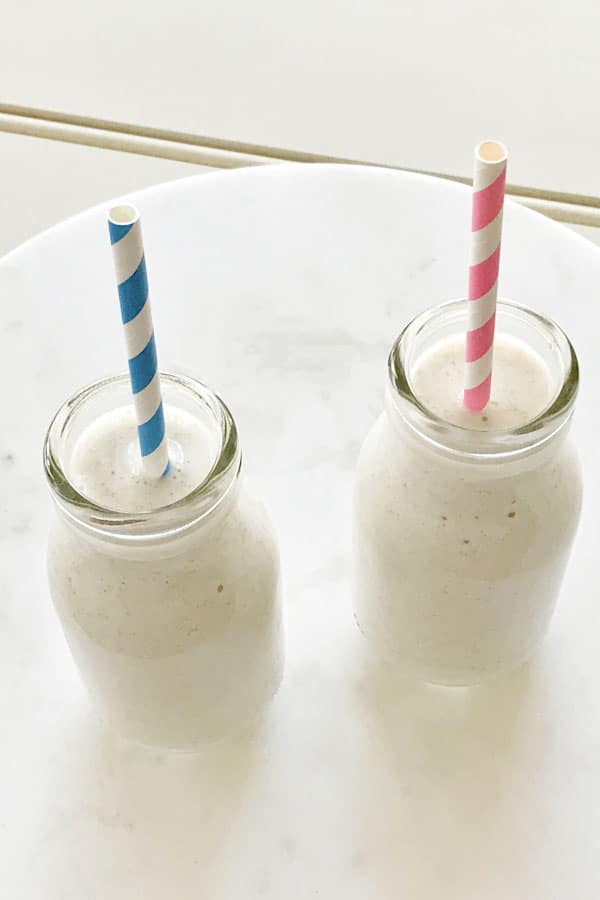 two small milk bottles filled with chia banana smoothie