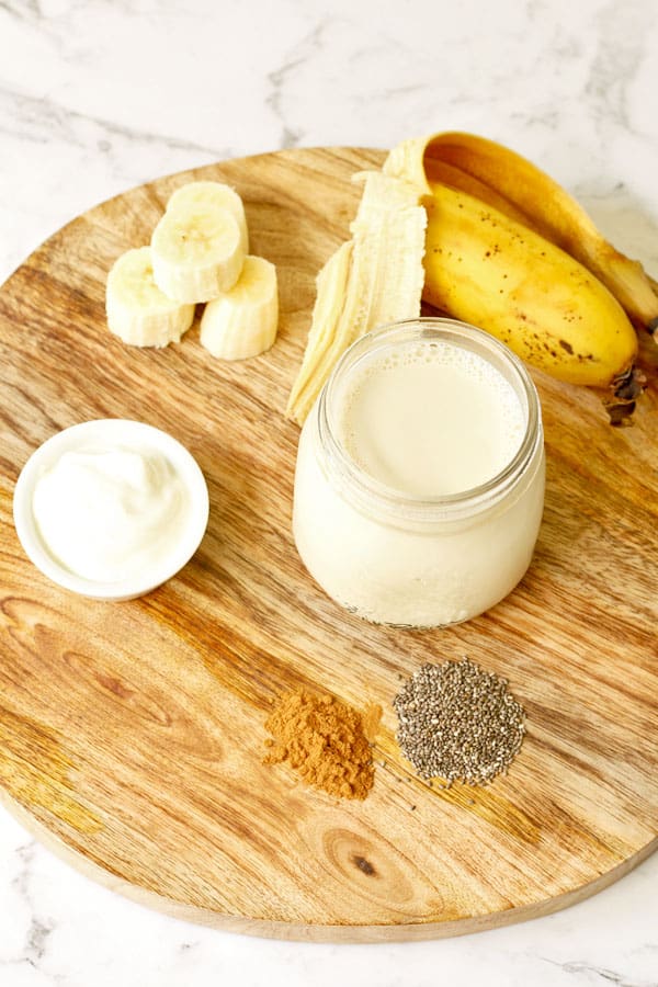 ingredients for chia banana smoothie laid out on wooden board