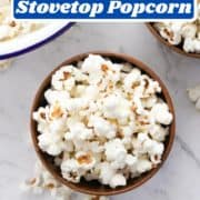 popcorn in a wooden bowl with text overlay "how to make stovetop popcorn".
