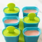 popsicle moulds filled with strawberry banana popsicle mix.