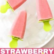 3 strawberry pineapple popsicles on a plate filled with ice cubes.