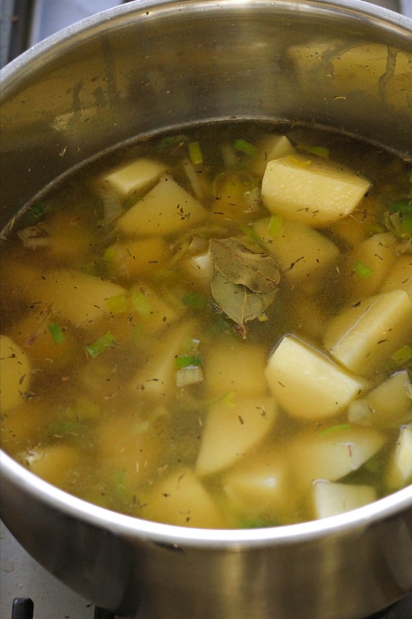 potato and leek soup ingredients in a saucepan. 