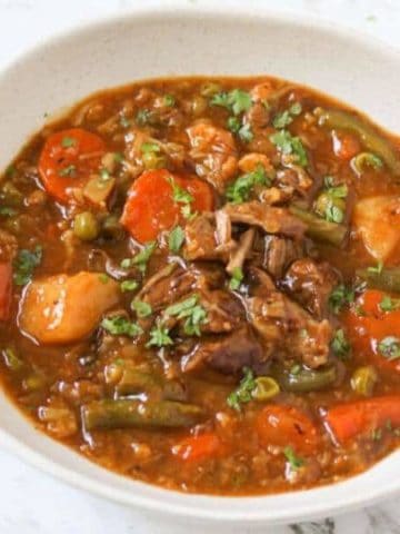 beef and vegetable stew in a white bowl