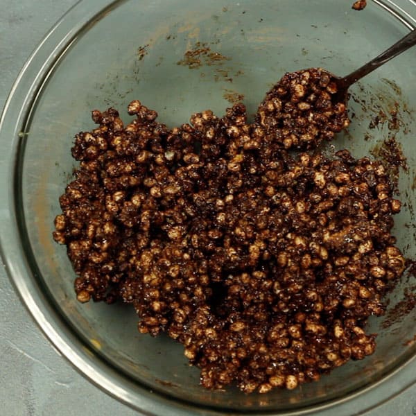 healthy chocolate crackles ingredients mixed together in a glass bowl 