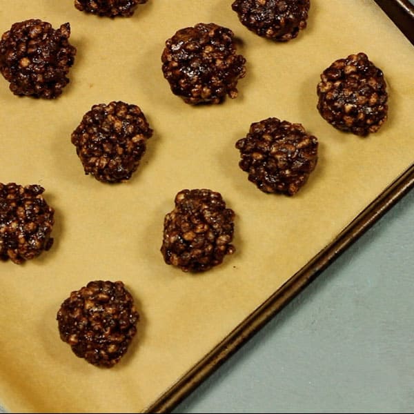 healthy chocolate crackles rolled into balls on a baking tray 