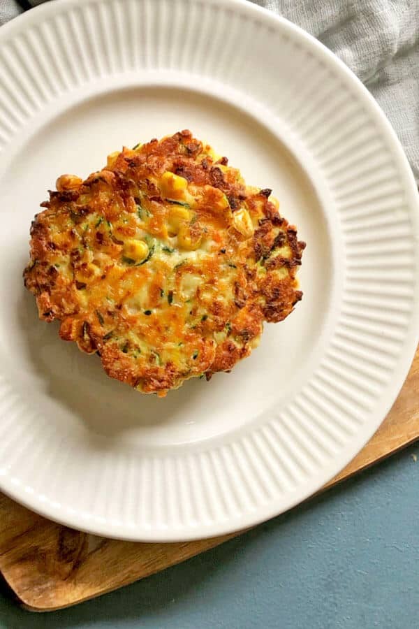 zucchini haloumi fritters on a white plate