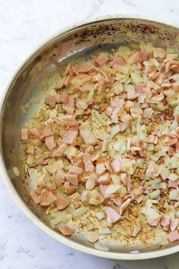 Bacon and onion in a frying pan. 