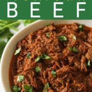 shredded mexican beef in a white bowl.