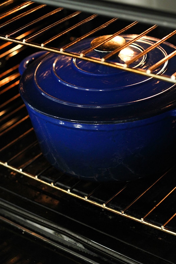 blue dutch oven in an oven.