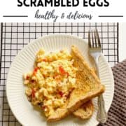 scrambled eggs on toast with text overlay "cheesy loaded scrambled eggs".