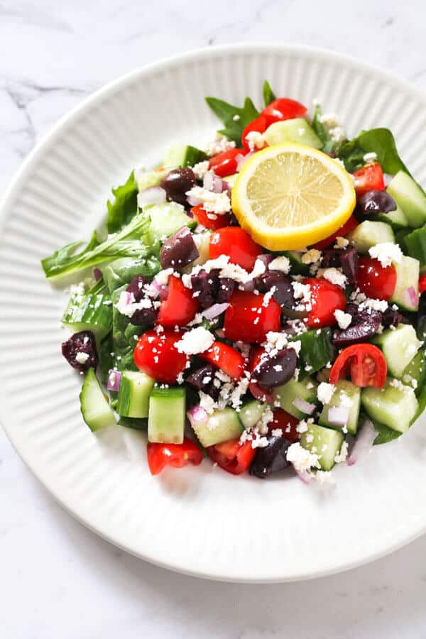 close up of a greek salad on a white plate