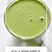 green smoothie in a glass with text overlay "kale pineapple smoothie".