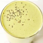 green smoothie topped with chia seeds with text overlay "spinach mango smoothie".