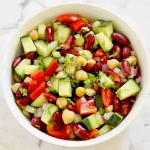 middle eastern bean salad in a white bowl