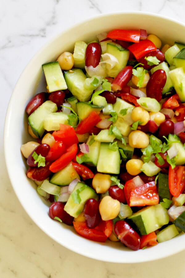 close up of middle eastern bean salad in a white bowl