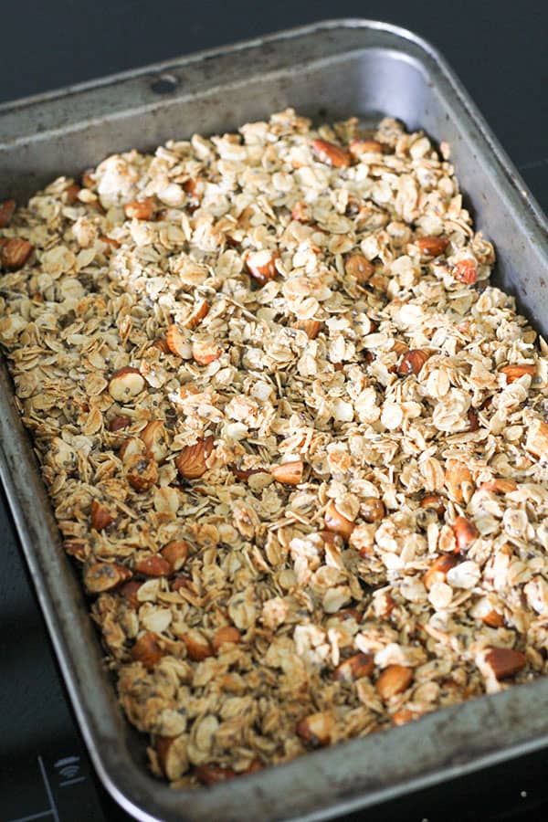 baked honey almond granola on a baking tray.