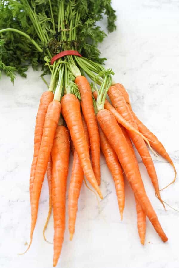 a bunch of baby dutch carrots on a marble background