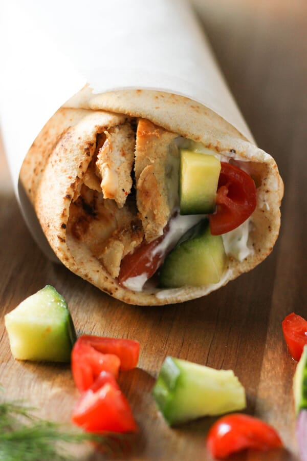 Chicken Gyro wrapped in parchment paper.