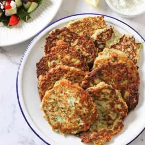 zucchini fritters on a white plate