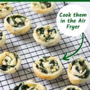 spinach and feta pinwheels on a wire rack.