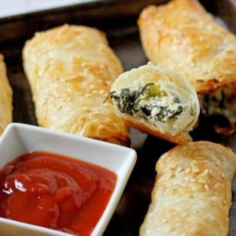 spinach and ricotta rolls on a baking tray.