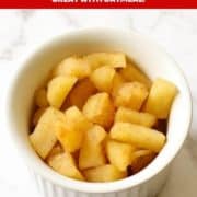 stewed cinnamon apple pieces in a white bowl with text overlay "stewed cinnamon apples".