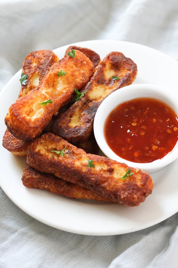a plate of halloumi fries with sweet chilli sauce.