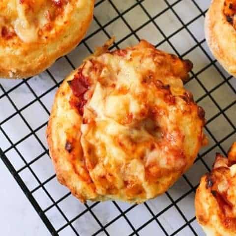 ham and cheese scrolls on a wire cooling rack.