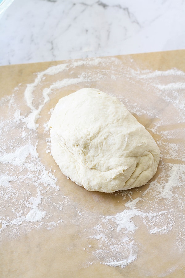 a ball of dough on a piece of parchment paper.