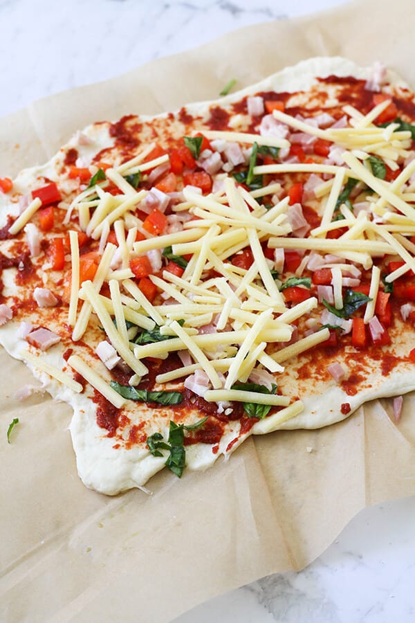 dough covered in pizza ingredients. 