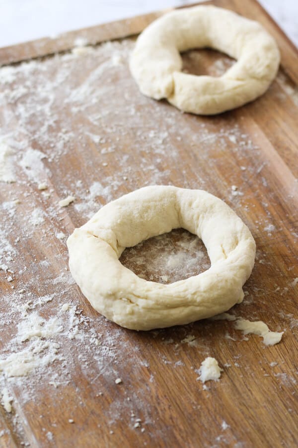 dough being shaped into a bagel.