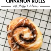 cinnamon roll on a wire rack covered with glaze with text overlay "no yeast cinnamon rolls".