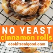 cinnamon roll on a wire rack covered with glaze with text overlay "no yeast cinnamon rolls".