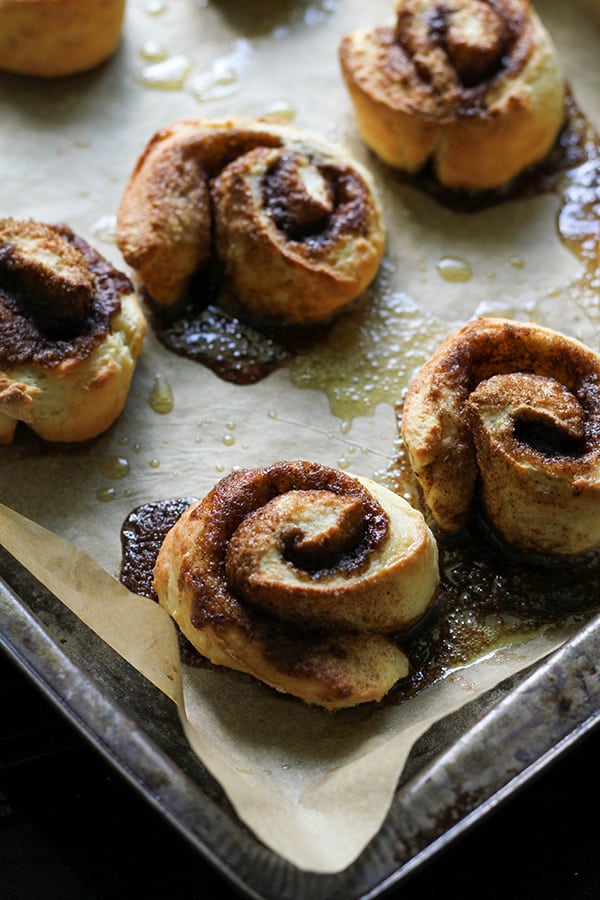 cinnamon rolls on a baking tray fresh out fo the oven.