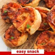 pizza scrolls piled on top of each other with text overlay "pizza scrolls with 2 ingredient dough".