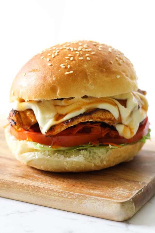 Grilled Chicken Burger on a wooden board.