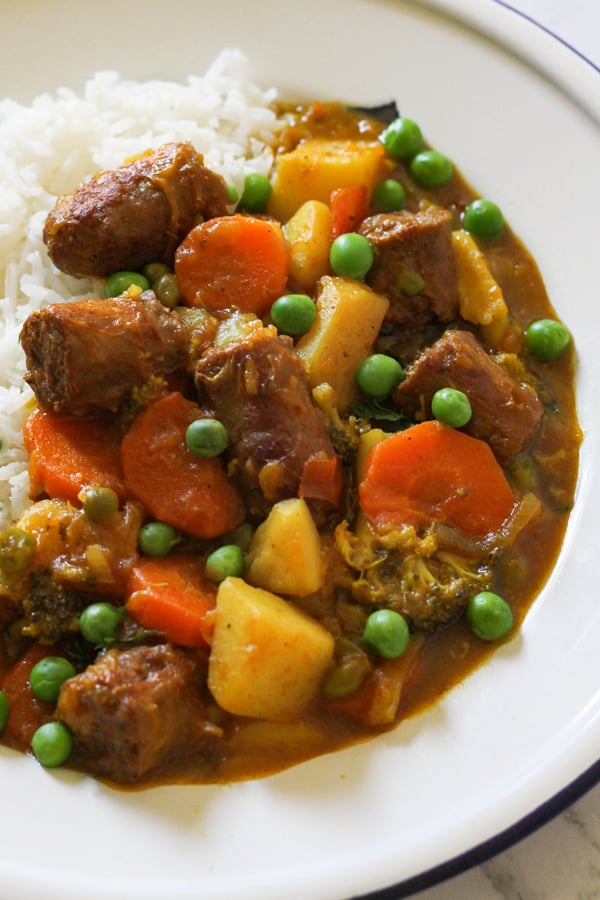 curried sausages on a bed of rice.