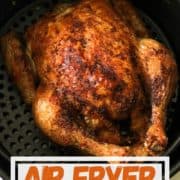 Whole roast chicken sitting in air fryer basket with text overlay "air fryer whole chicken".