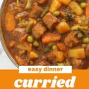 curried sausages in a big bowl with text overlay "curried sausages".