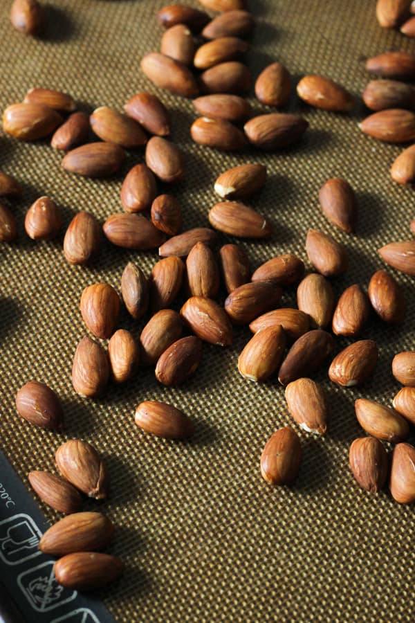 roasted almonds on a baking tray.