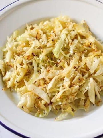 sauteed cabbage in a white bowl.