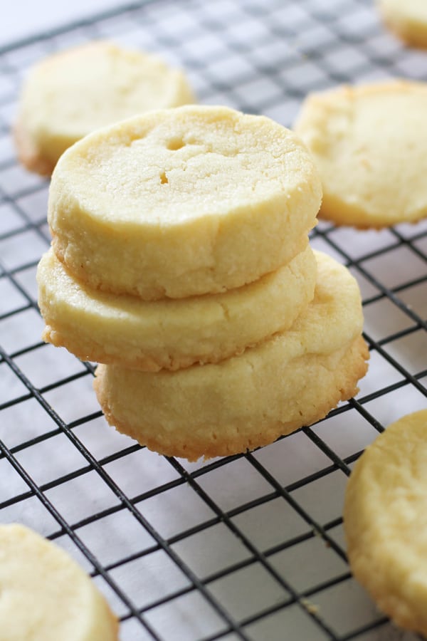 shortbread cookies stacked on top of a wire rack.