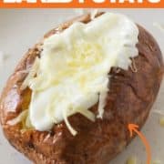 baked potato topped with sour cream and cheese.