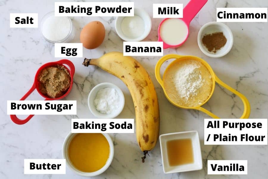 Mini banana bread ingredients on a white marble board.