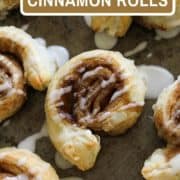 cinnamon rolls on a baking tray with text overlay "puff pastry cinnamon rolls".