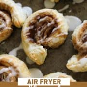 cinnamon rolls on a baking tray with text overlay "puff pastry cinnamon rolls".