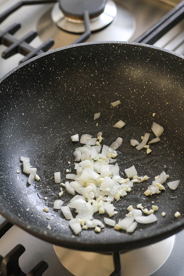 onion and garlic in a wok.