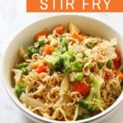 vegetable stir fry with noodles in a white bowl.