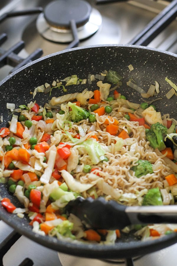 vegetable stir fry with noodles in a wok.